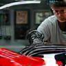 Technician inspecting finished car